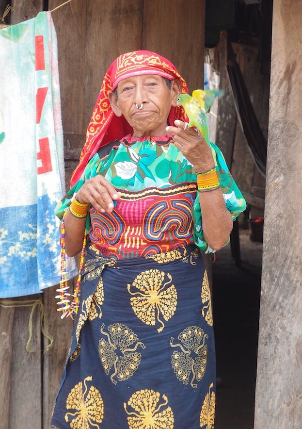 Kuna Woman in Traditional Clothing Holding Bird (San Blas, Panama)